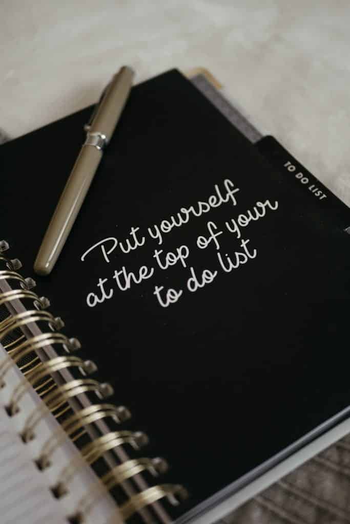 close-up of a notebook with the handwritten phrase "Put yourself at the top of your to-do list," emphasizing the importance of self-care.